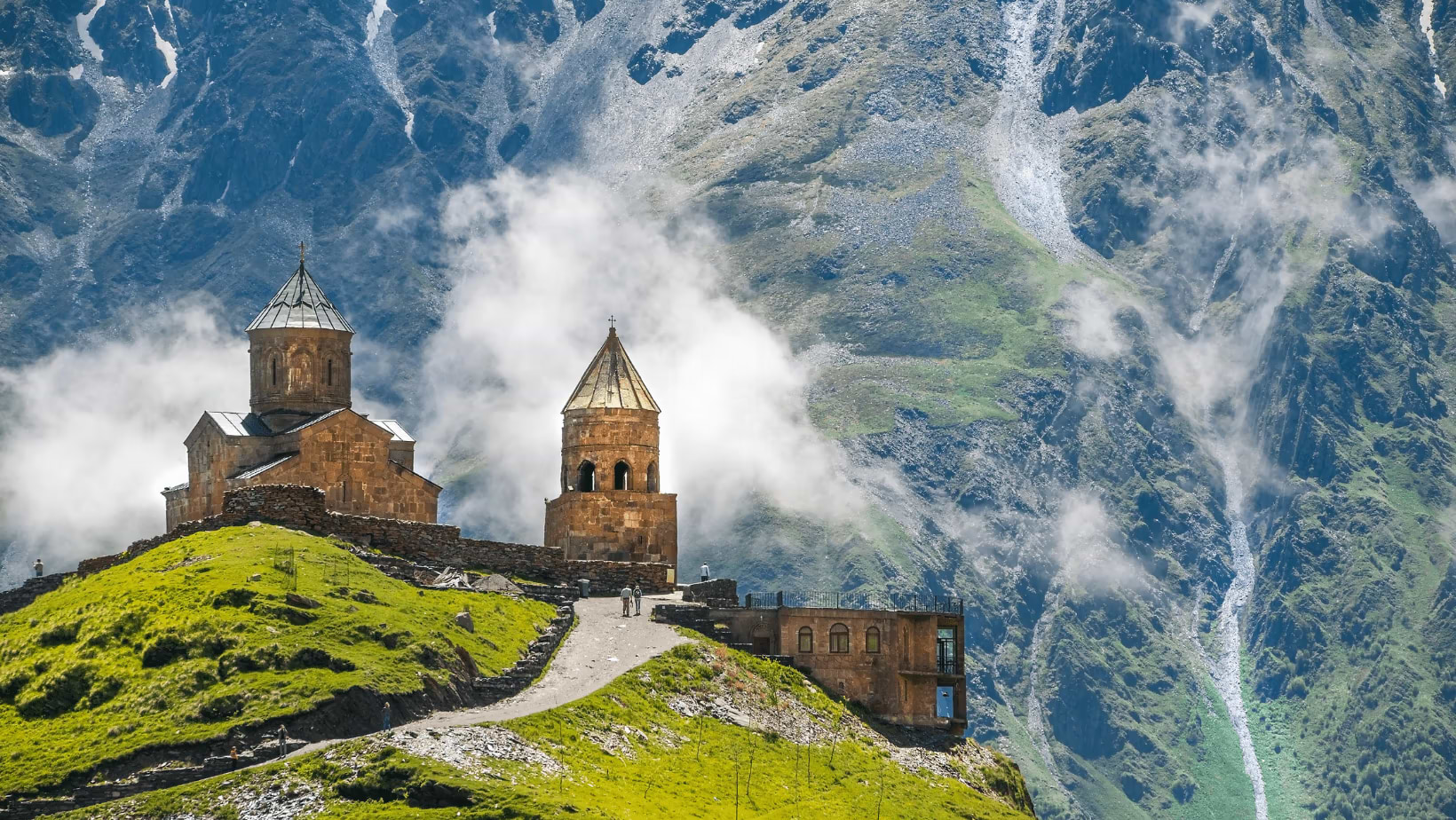 An ancient Georgian castle against a mountain background