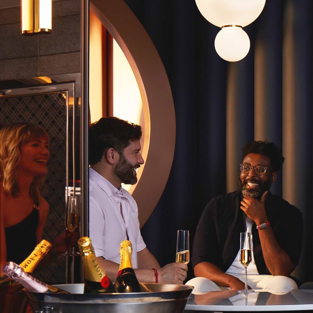 Three people hanging out and drinking champagne at the Sip Lounge